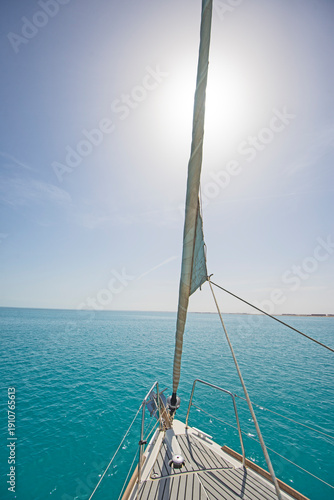 Wallpaper Mural Landscape view from the bow of a luxury sailing yacht bow on tropical blue sea with jib sail in foreground and ocean background  Torontodigital.ca