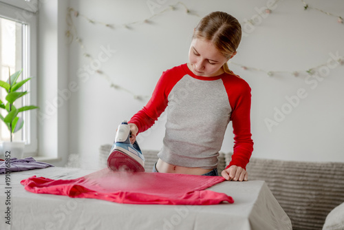 Teen Girl Ironing Shirt At Home