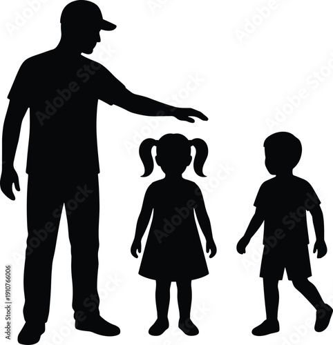 Silhouette of a father standing with his young son and daughter representing family protection parenthood childhood and caring male parent