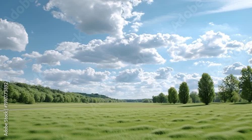 Wallpaper Mural A serene landscape with lush grass and scattered clouds under blue skies. Torontodigital.ca