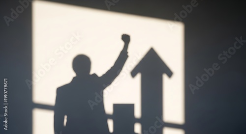 Wallpaper Mural Silhouette of a businessman raising his fist in victory with a rising graph projection. Torontodigital.ca