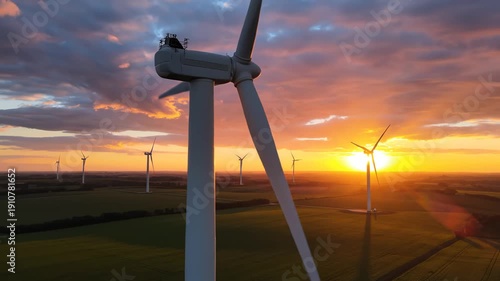 Wind turbines at sunset in a field