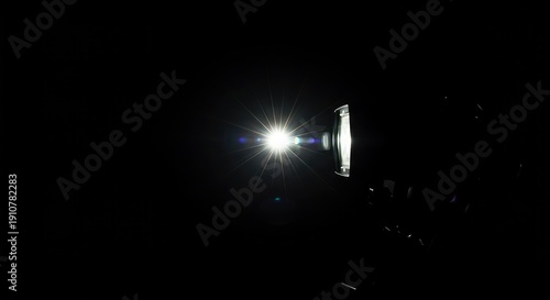 A camera flash illuminates a dark environment, momentarily capturing movement or a static scene with a burst of bright light ,strobe ,low ,capture