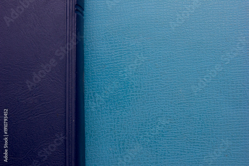 Close-up full frame photo of a stack of blue-covered Bibles, background and texture