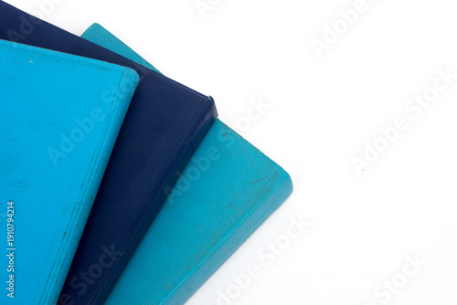 Close-up full frame photo of a stack of blue-covered Bibles, background and texture