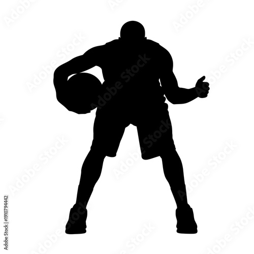 Silhouette of a basketball player dribbling the ball with determination and focus.