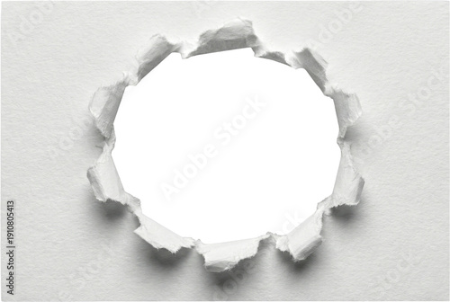 Ripped circular hole in center of white textured paper