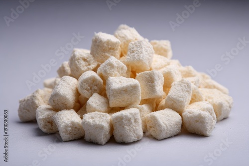 Pile of Sugar Cubes on Light Background