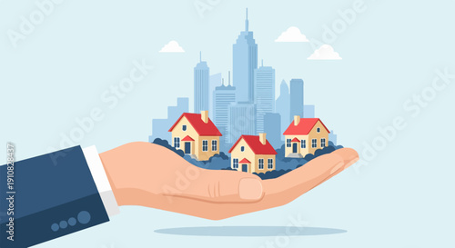 Hand holding houses against cityscape