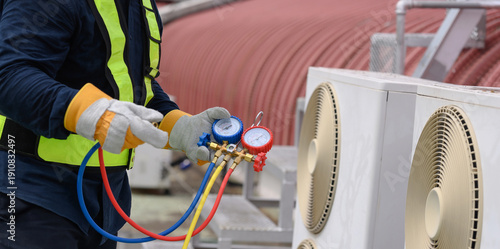 Technician is checking air conditioner ,measuring equipment for filling air conditioners.