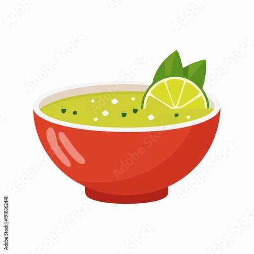 Fresh avocado dip in a red bowl with lime and green garnish