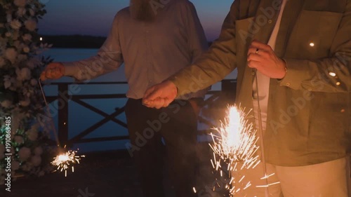 Bengal lights burning in a person's hand