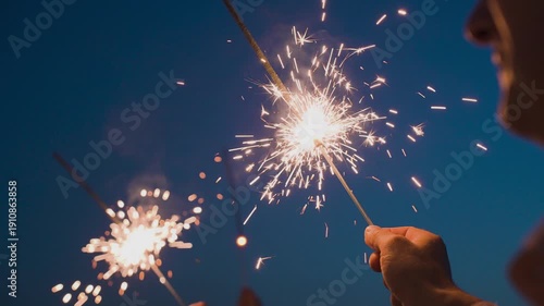 Bengal lights burning in a person's hand