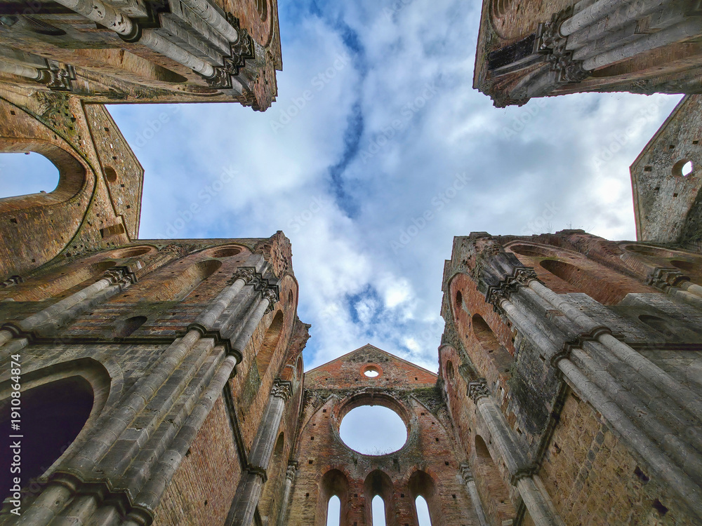 Obraz premium Low Angle View of Roofless Gothic Arches and Sky in San Galgano Abbey, Tuscany, Italy