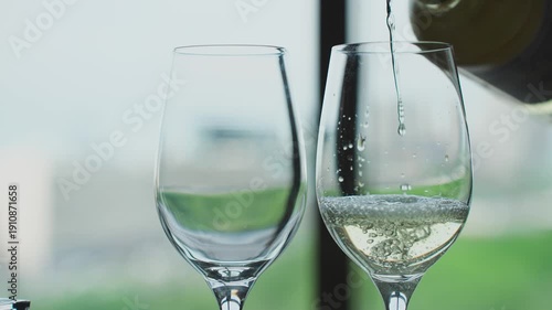 White wine is poured into glasses