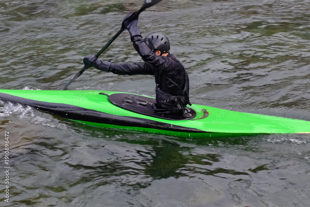 Fototapeta premium Canoe Slalom Athlete Paddling Through River Gates