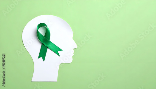 Wallpaper Mural mental health awareness concept featuring a green ribbon on a white human head silhouette, pastel green background. Generative AI. Torontodigital.ca