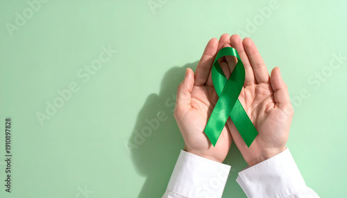 Wallpaper Mural Healthcare professional holding a green awareness ribbon in hands, mental health and medical support concept. Generative AI. Torontodigital.ca