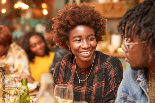 Two friends enjoy a lively conversation at a cozy restaurant, sharing smiles and warmth in a vibrant social setting.