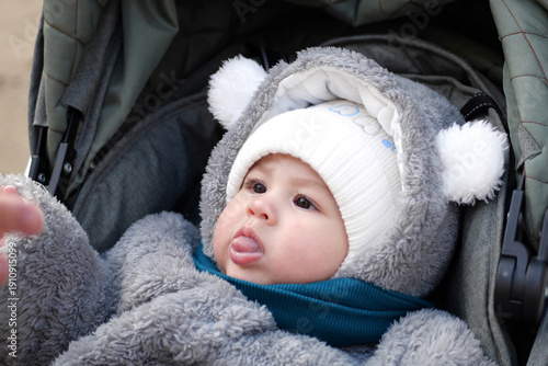 Wallpaper Mural Happy little baby boy making outdoors in winter. Cute toddler in winter cloth. Child having fun on cold day. Winter walk outdoors Torontodigital.ca
