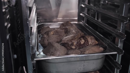 Roasted beef trays in a commercial oven