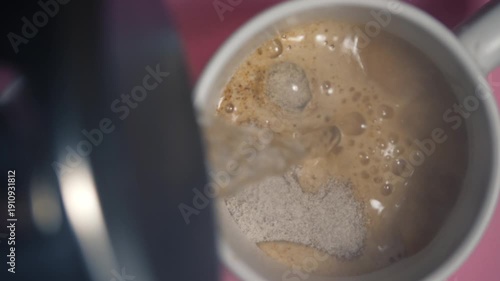 Make hot mug of instant cappuccino coffee on pink background