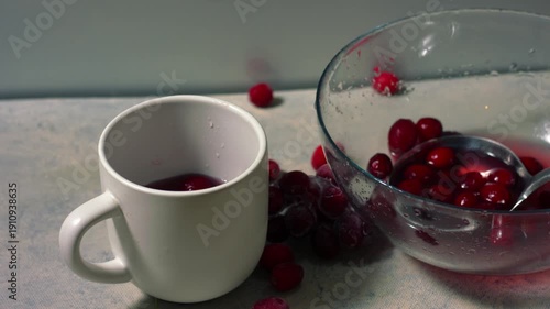 Serving of red ripe cranberry juice in a mug
