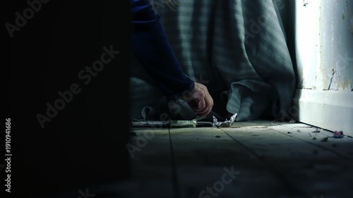 Door opens to reveal addict cutting Illegal drugs in abandoned house