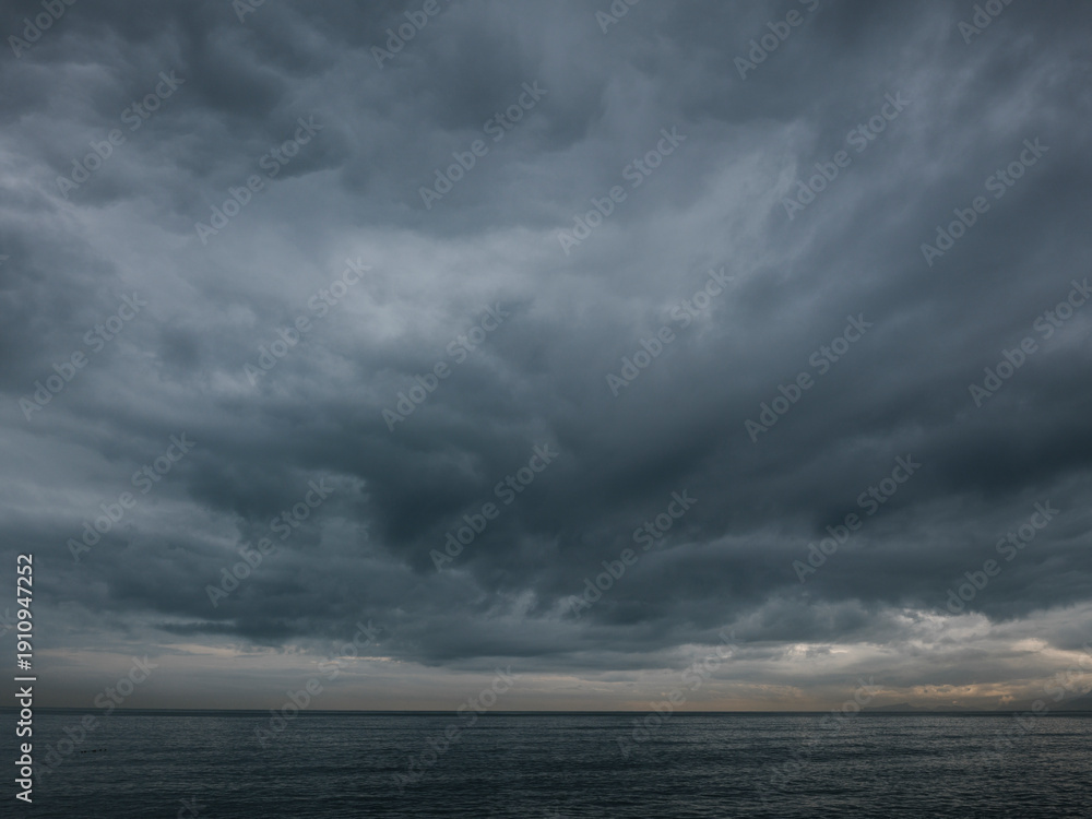 Fototapeta premium Rain clouds over calm sea