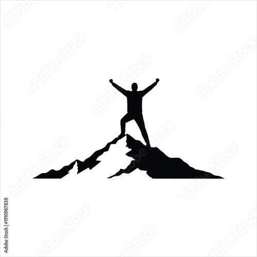 Silhouette of a triumphant hiker standing with arms raised on the peak of a rugged mountain