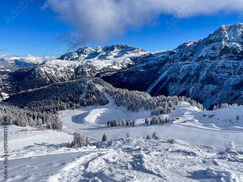 Schilderij op canvas A vast alpine panorama photographed from the area of Giustino shows a winter landscape of the Dolomites under bright, clear sunlight