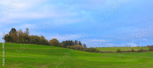 A tranquil rural landscape under a dramatic sky