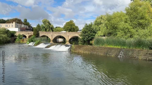 River Avon flowing over weir at Bathampton, Somerset on sunny summer day