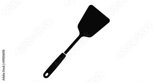 A simple black silhouette depicts a kitchen spatula angled slightly against a stark white background high quality professional