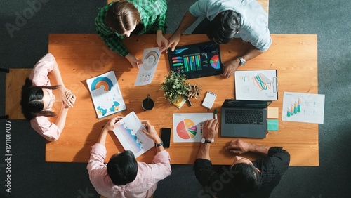 Photos Top view of diverse business people working together to analyze chart