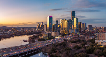 Aerial drone view of sunset over the dramatic skyline of Austin Texas in early 2026 showing new residential towers in downtown