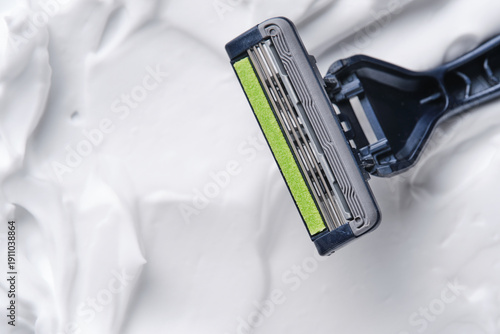 Close up of razor blade head with lubricating strip on foam.
