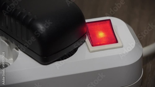 Black power adapter is take out the electric portable socket with red power and on indicator
