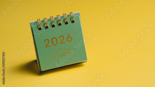 2026 calendar on yellow background, showcasing modern design with spiral binding. This vibrant image captures essence of planning and organization