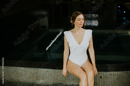 Woman in swimsuit sitting b...