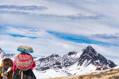 Wallpaper Mural A local Andean woman standing against the snow-capped Andes Mountains near Rainbow Mountain (Vinicunca), Peru Torontodigital.ca