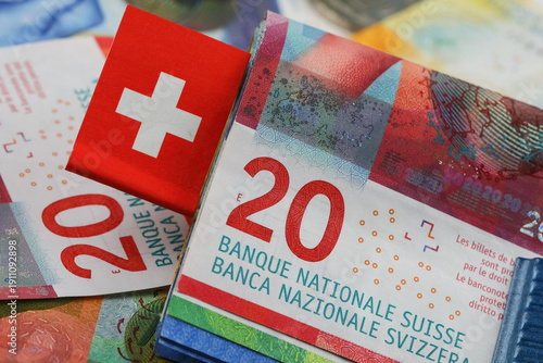 Twenty-franc banknotes and the national flag of Switzerland