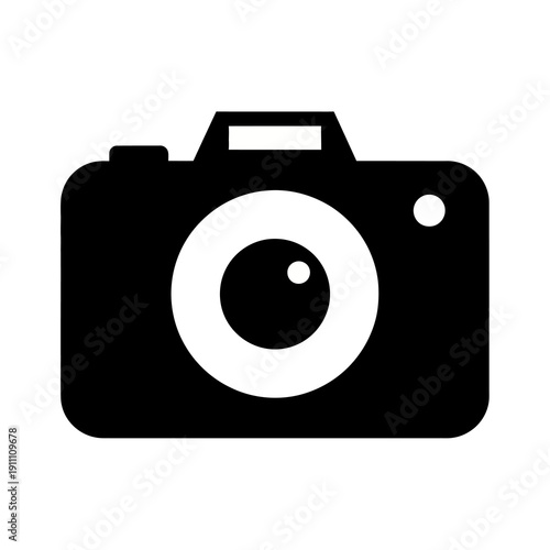 A bold, minimalist black and white icon representing a modern digital camera with a prominent circular lens on transparent background