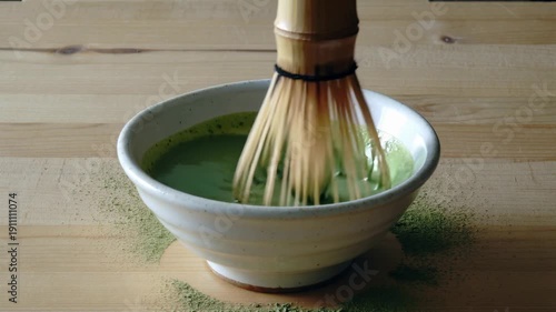 Preparing traditional japanese matcha green tea with bamboo whisk