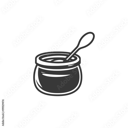 A small jar filled with something and a small spoon