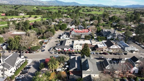 Los Olivos, California, USA – Elevated Aerial View of Downtown Grand Avenue With Restaurants, Small-Town Commercial Buildings, and the Santa Ynez Valley Mountains in the Background