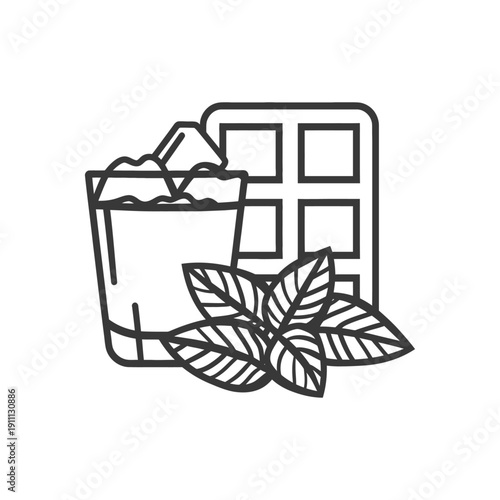 A glass with ice a waffle and some fresh mint leaves