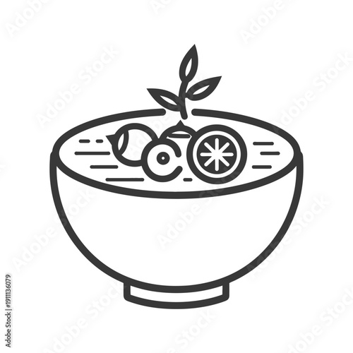 A bowl containing soup and fruits with a sprig of leaves
