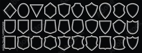 Comprehensive collection of 36 minimalist white shield and badge outlines in diverse heraldic shapes on black background for professional logo design, security emblems and insignia AI Generative