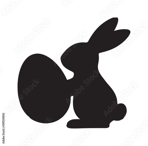 Black silhouette of an Easter bunny rabbit sitting in profile while holding a large decorative egg, a minimalist graphic icon for the spring holiday celebration and tradition